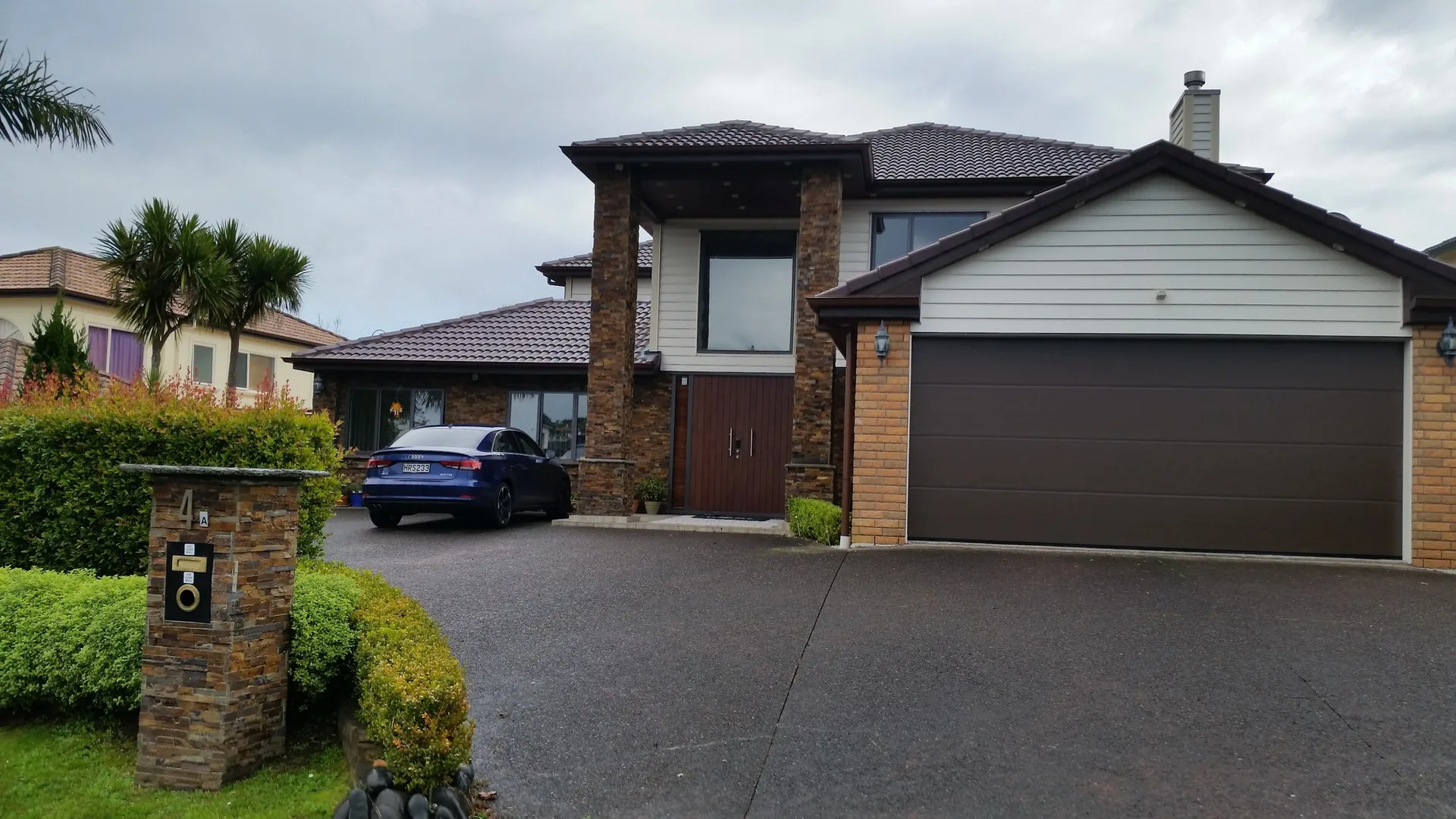 Brick and stone home exterior completed by JHJ Homes in Auckland