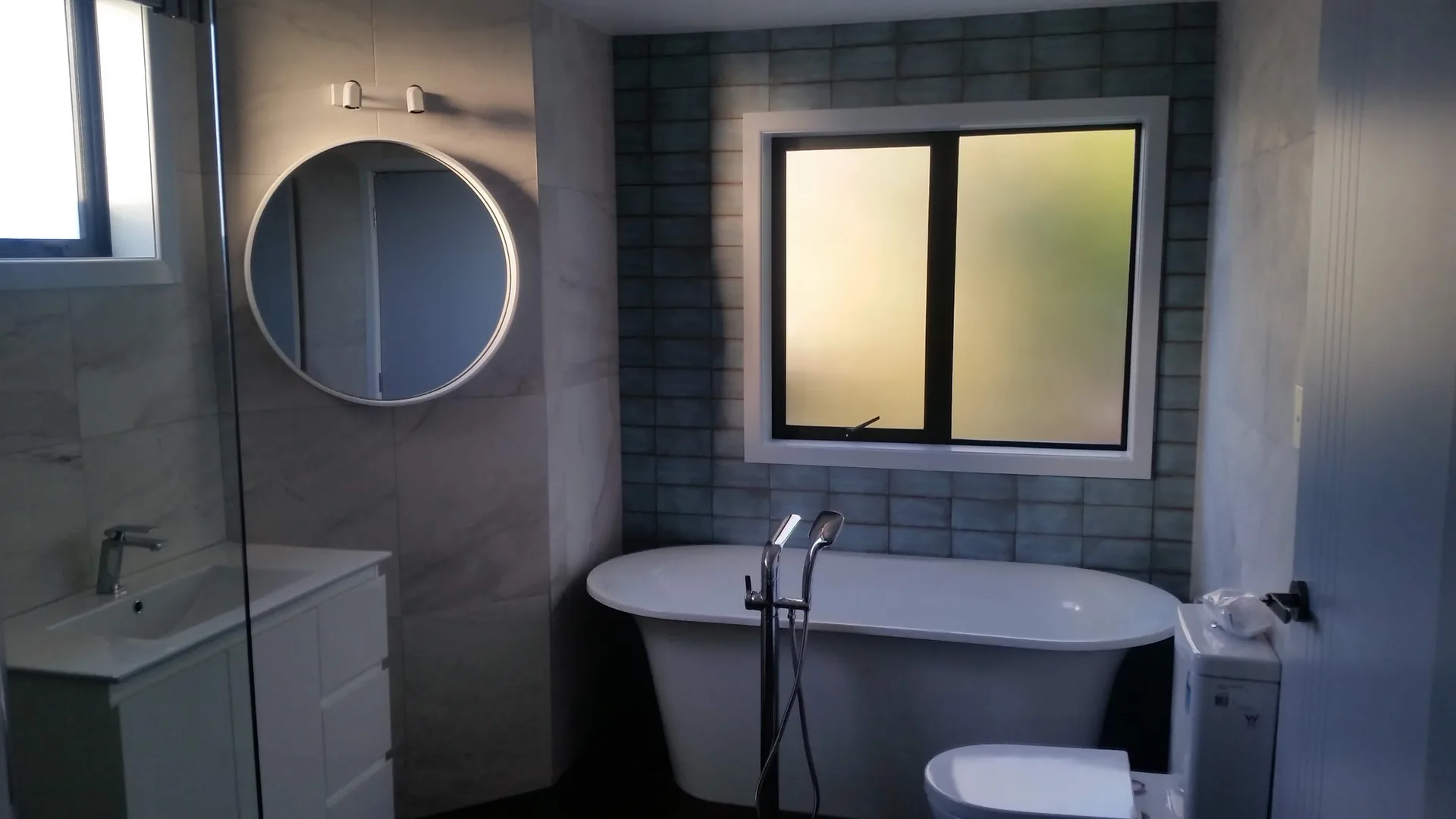Luxury bathroom renovation with freestanding bath by JHJ Homes