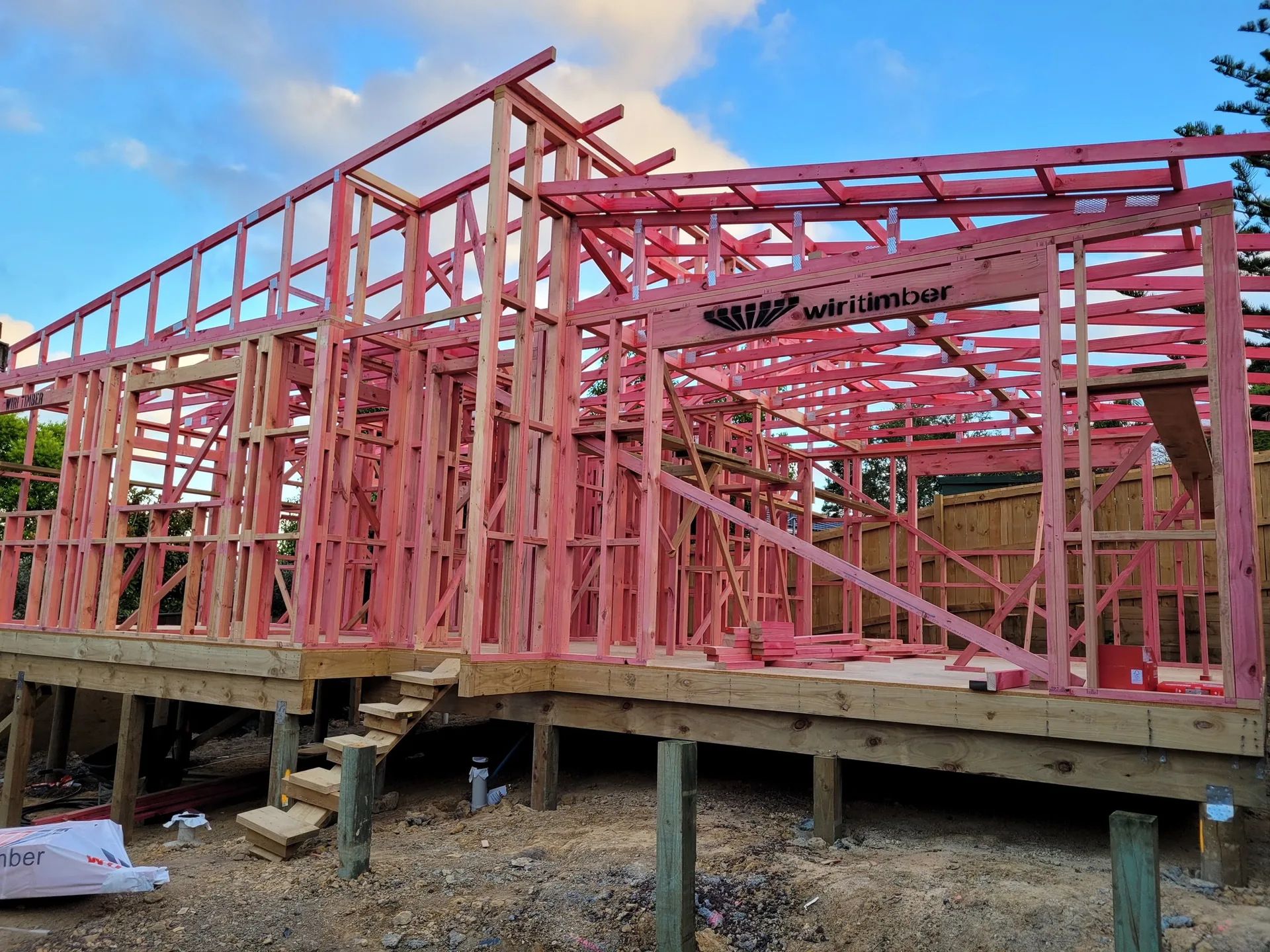 New build timber framing at golden hour by JHJ Homes